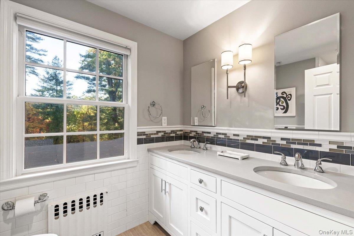 6 Valley Place Harrison, NY 10528 - Photo 24 of 37 a bathroom with a sink and a mirror