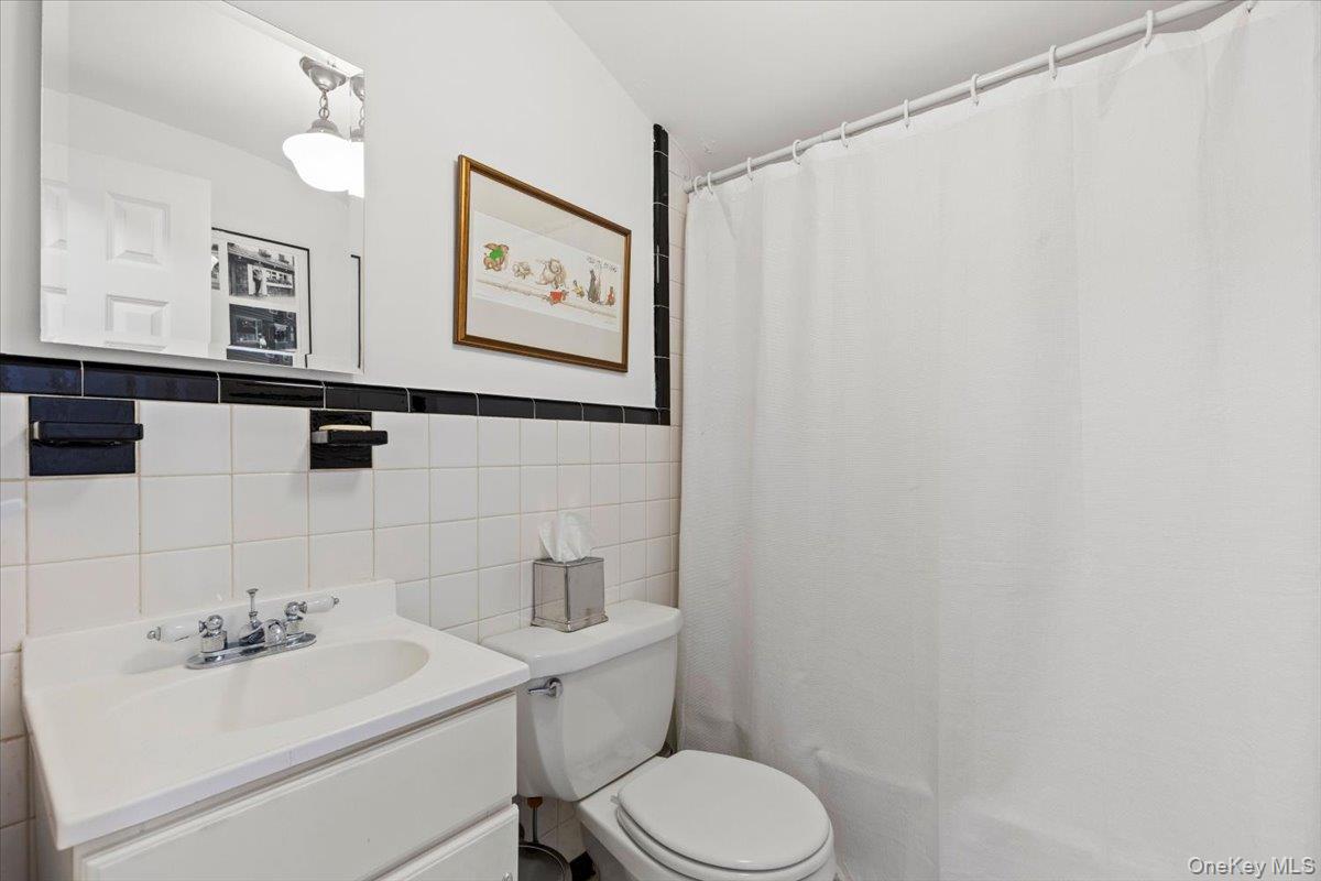6 Valley Place Harrison, NY 10528 - Photo 27 of 37 a bathroom with a toilet sink and mirror