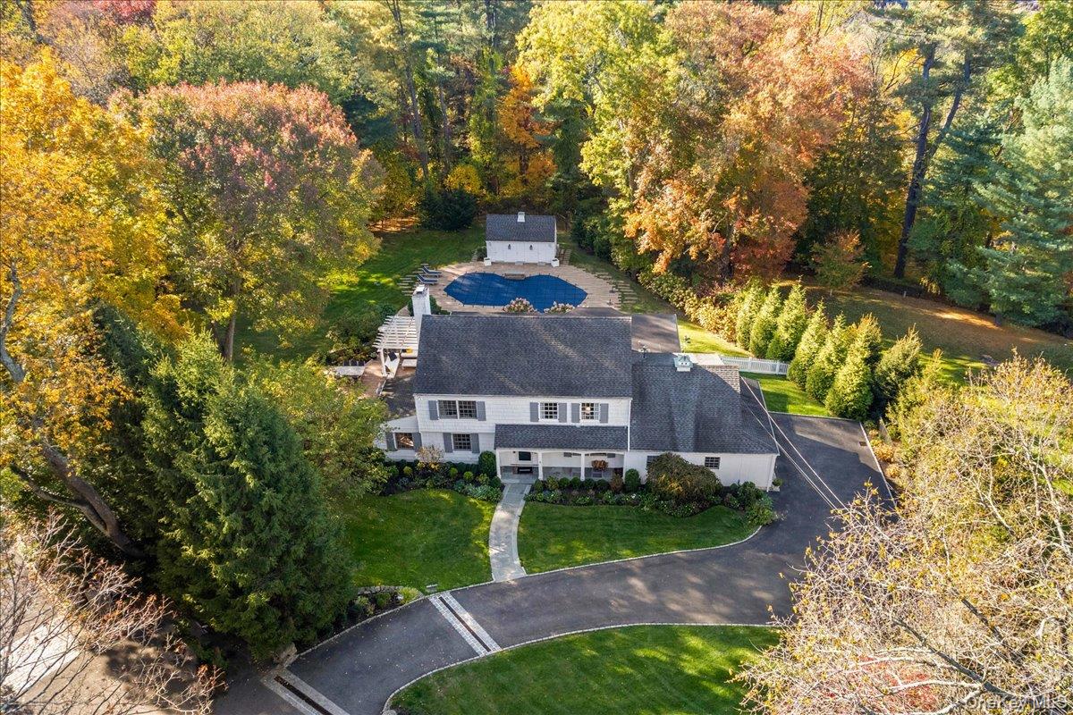 6 Valley Place Harrison, NY 10528 - Photo 33 of 37 a aerial view of a house with a yard and large trees