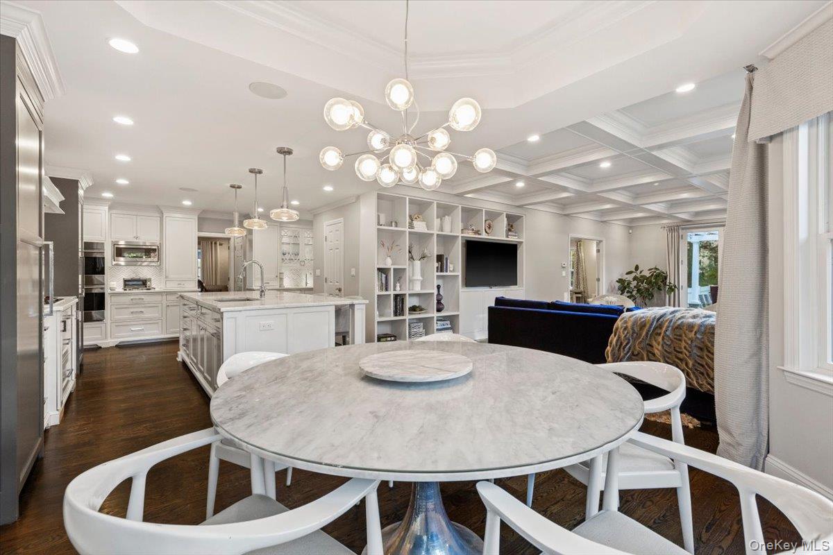 6 Valley Place Harrison, NY 10528 - Photo 6 of 37 a kitchen with kitchen island a stove a table and chairs