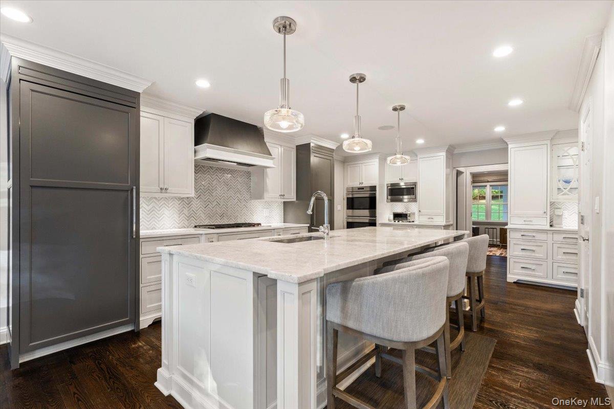 6 Valley Place Harrison, NY 10528 - Photo 7 of 37 a kitchen with stainless steel appliances granite countertop a kitchen island a stove a refrigerator a oven a sink with island and chairs