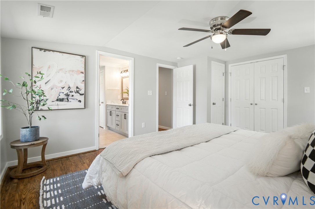 6304 Engel Road Richmond, VA 23226 - Photo 12 of 37 a spacious bedroom with a bed and a chandelier