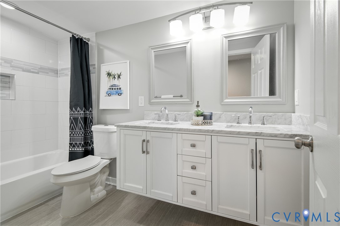 6304 Engel Road Richmond, VA 23226 - Photo 25 of 37 a bathroom with a toilet a sink a mirror a bathtub and vanity