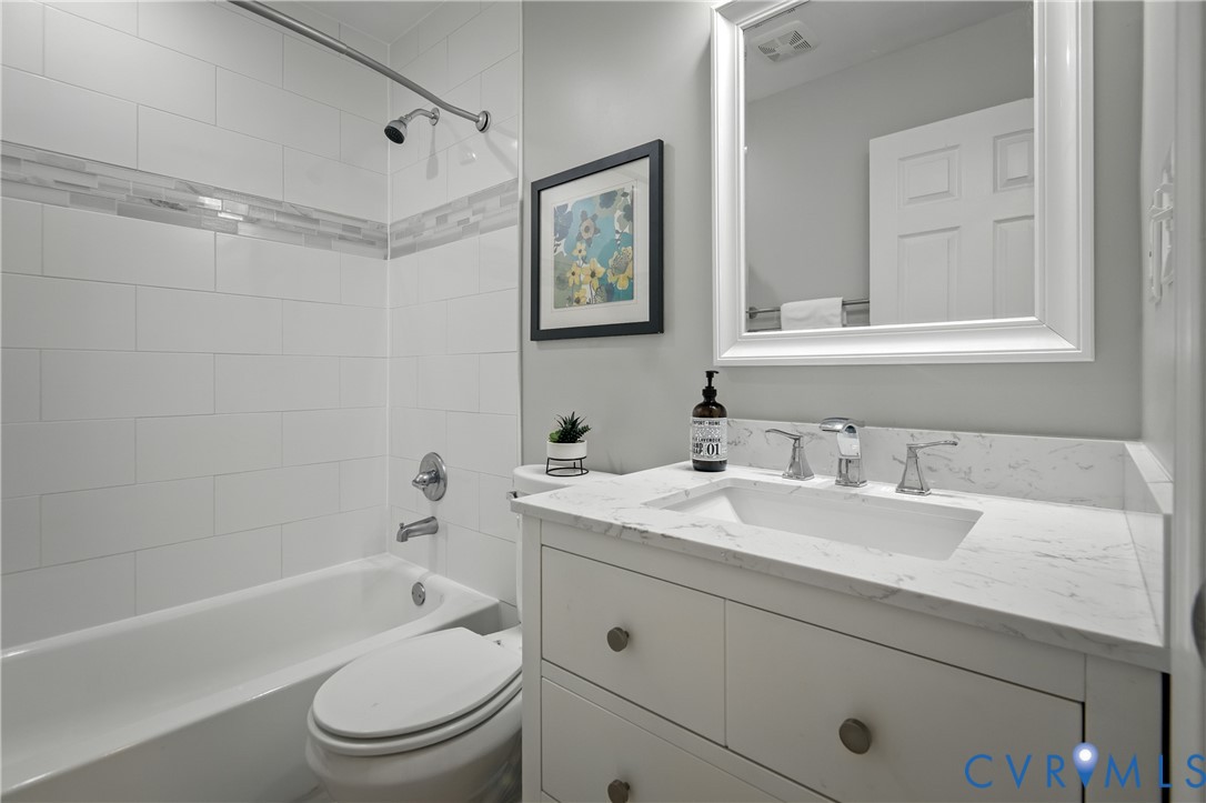 6304 Engel Road Richmond, VA 23226 - Photo 27 of 37 a bathroom with a granite countertop sink toilet and shower