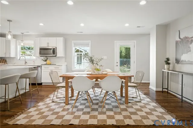a large kitchen with a table and chairs