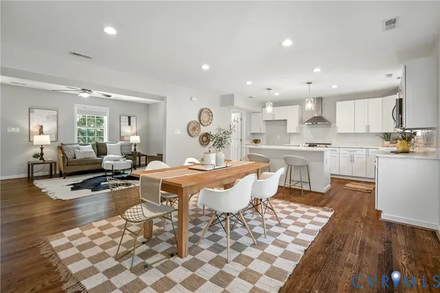 a kitchen with a dining table chairs and white appliances