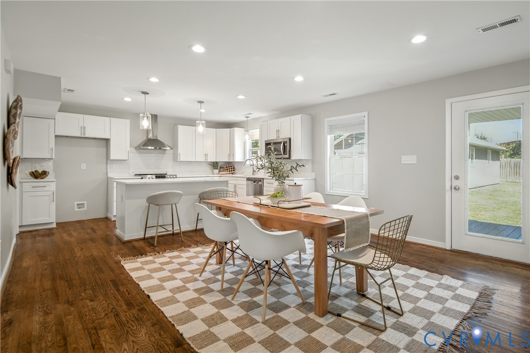 6304 Engel Road Richmond, VA 23226 - Photo 7 of 37 a kitchen with a dining table chairs and white appliances