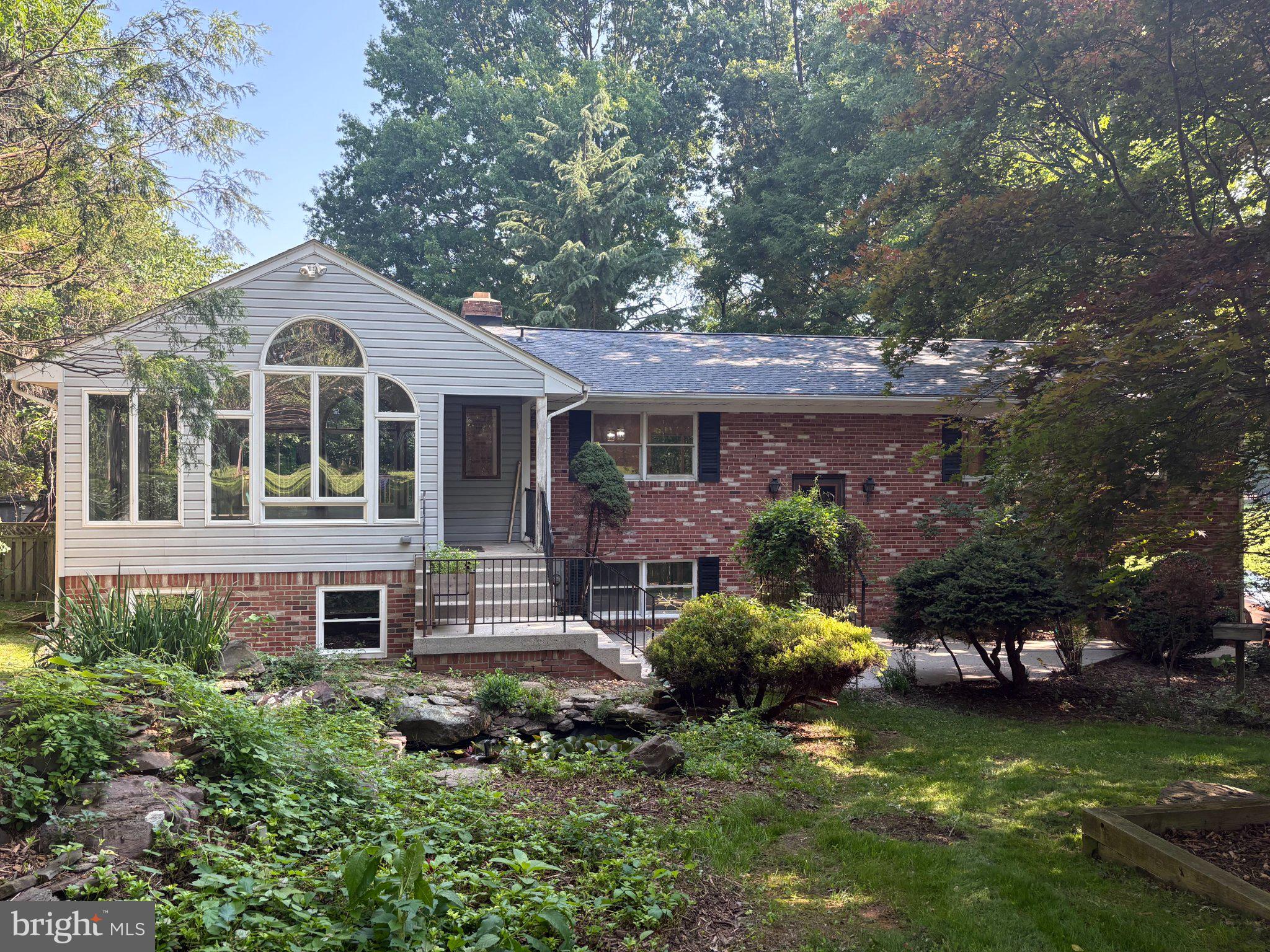 13715 Lewisdale Road Clarksburg, MD 20871 - Photo 1 of 3 Charming brick home with lush greenery.