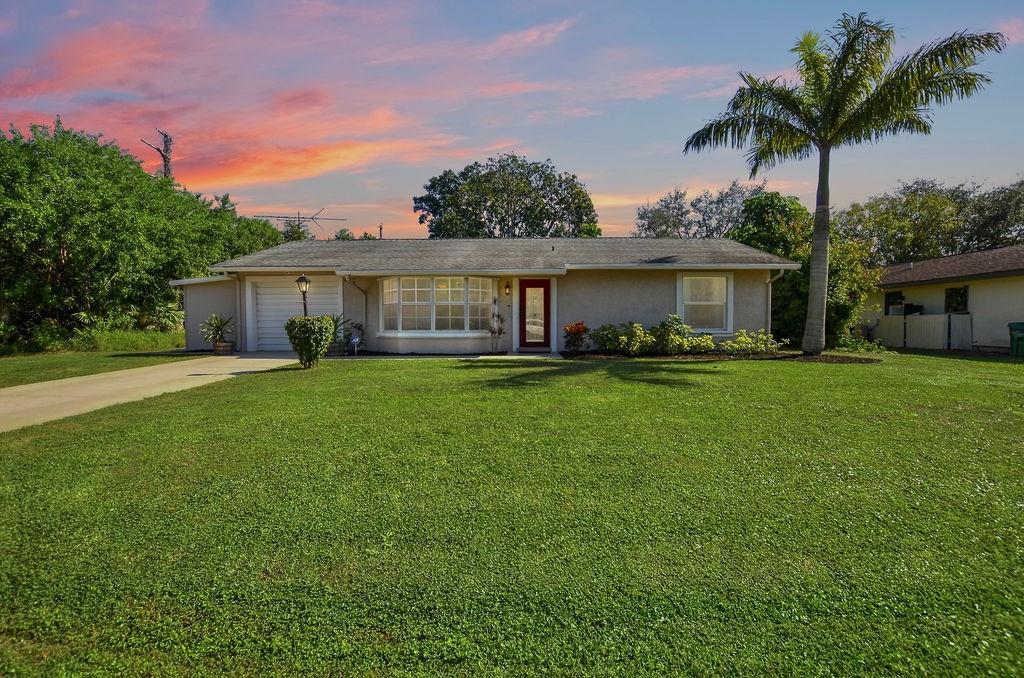 a front view of house with yard and green space
