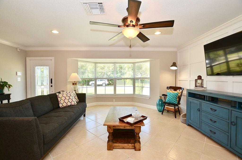 459 Southwest Byron Street Port St. Lucie, FL 34983 - Photo 11 of 51 a living room with furniture and a flat screen tv