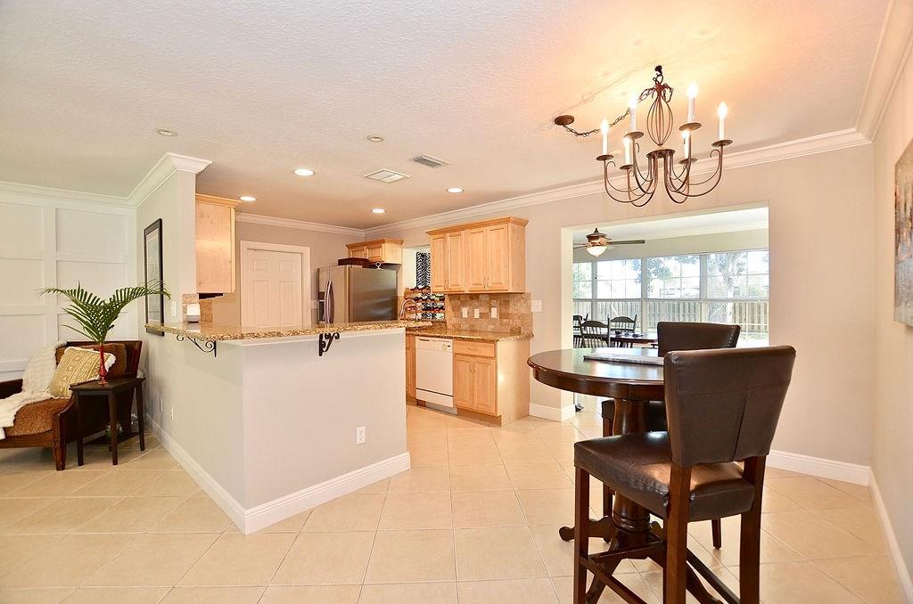 459 Southwest Byron Street Port St. Lucie, FL 34983 - Photo 14 of 51 a view of kitchen with dining table and chairs