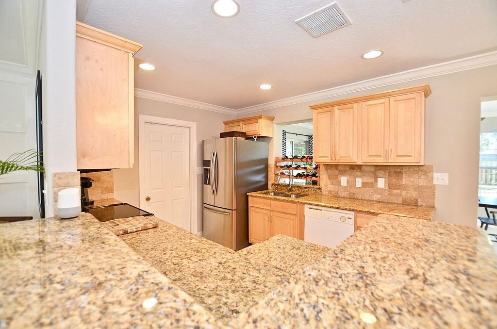 459 Southwest Byron Street Port St. Lucie, FL 34983 - Photo 15 of 51 a large kitchen with kitchen island sink granite counter tops and a window