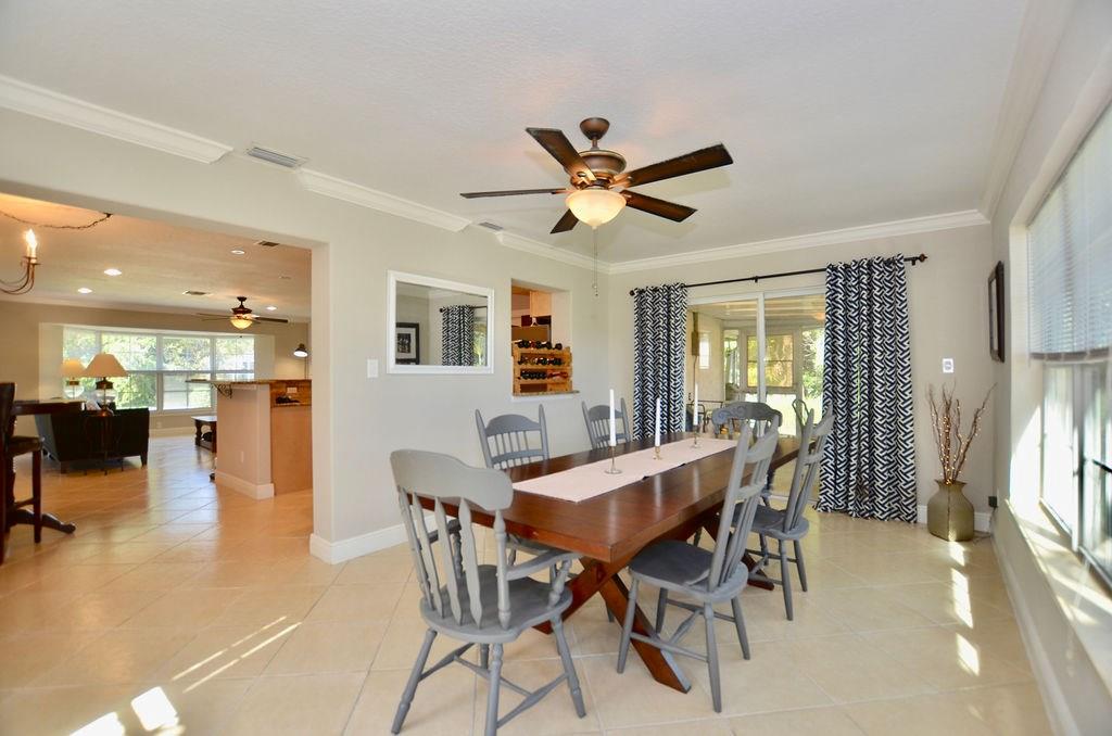 459 Southwest Byron Street Port St. Lucie, FL 34983 - Photo 19 of 51 a view of a dining room with furniture and a large window