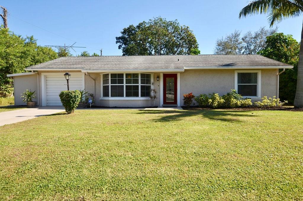 459 Southwest Byron Street Port St. Lucie, FL 34983 - Photo 2 of 51 a front view of house with yard and outdoor seating