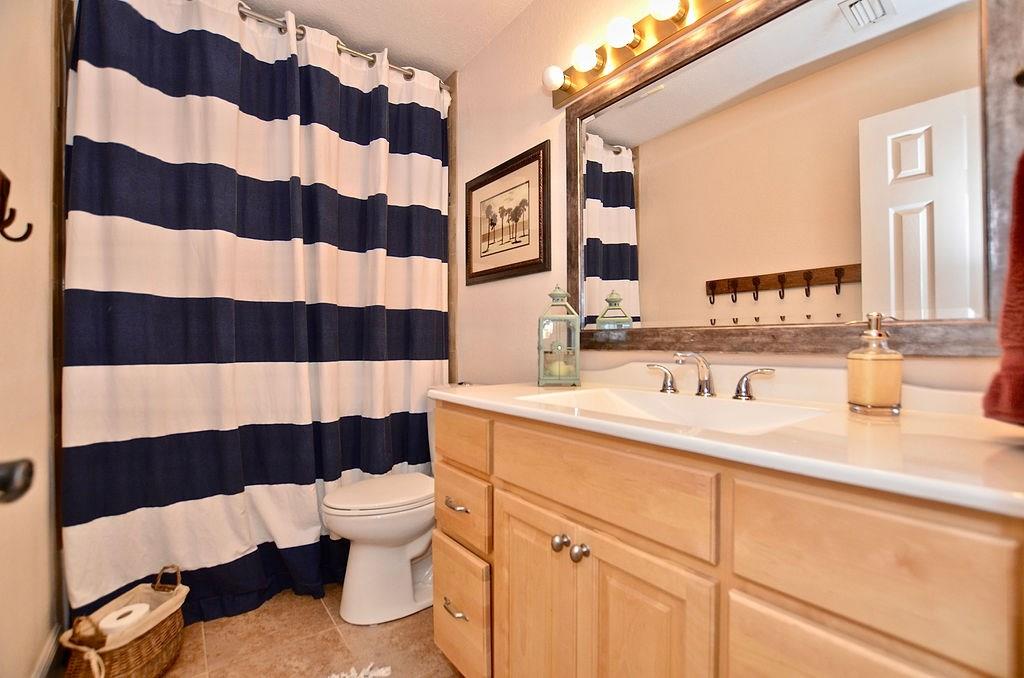 459 Southwest Byron Street Port St. Lucie, FL 34983 - Photo 24 of 51 a bathroom with a sink a toilet a shower and a mirror