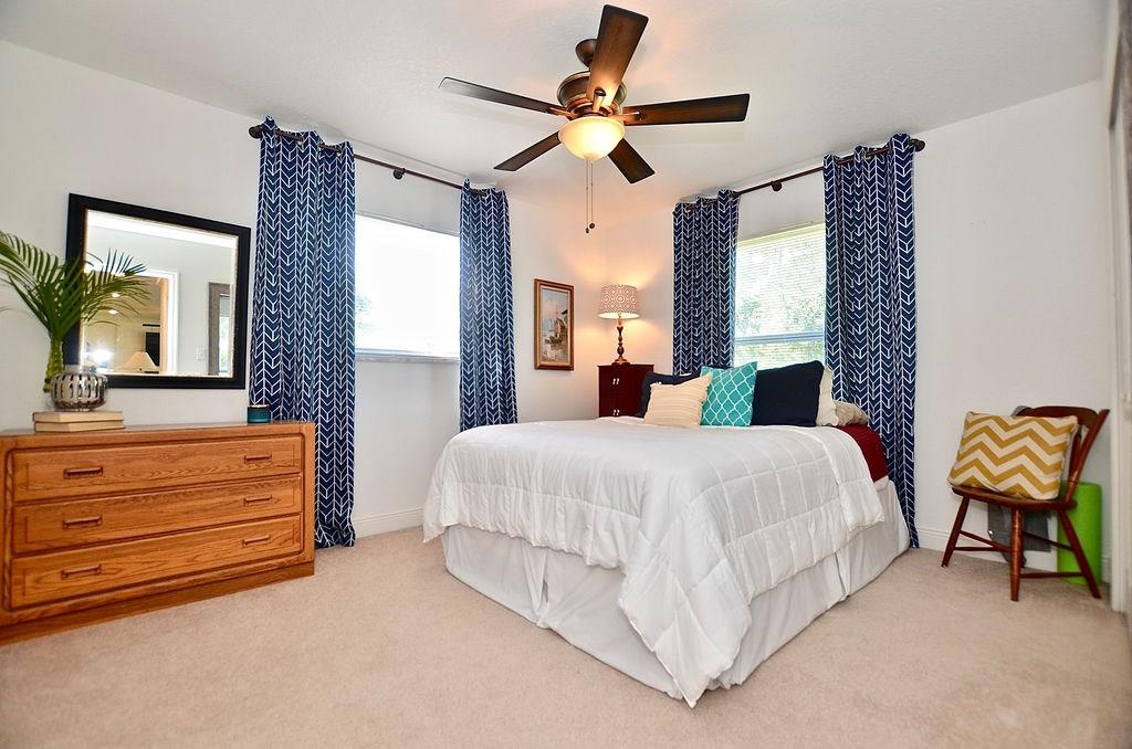 459 Southwest Byron Street Port St. Lucie, FL 34983 - Photo 25 of 51 a bed room with a bed and a chandelier