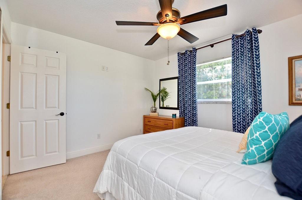 459 Southwest Byron Street Port St. Lucie, FL 34983 - Photo 27 of 51 a bedroom with a bed and a chandelier