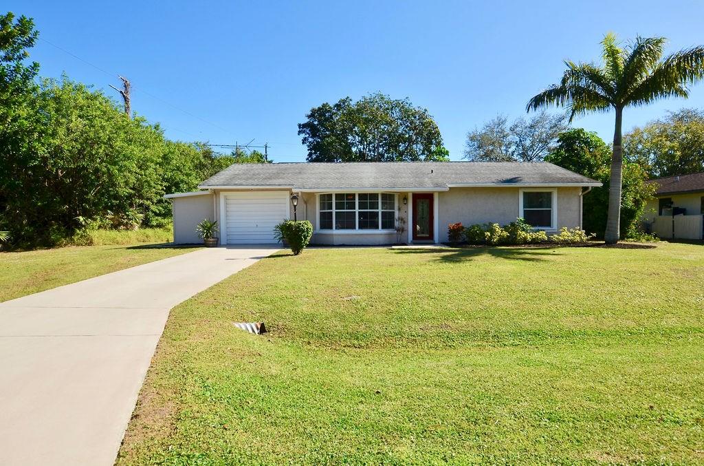 459 Southwest Byron Street Port St. Lucie, FL 34983 - Photo 3 of 51 a front view of house with yard and green space