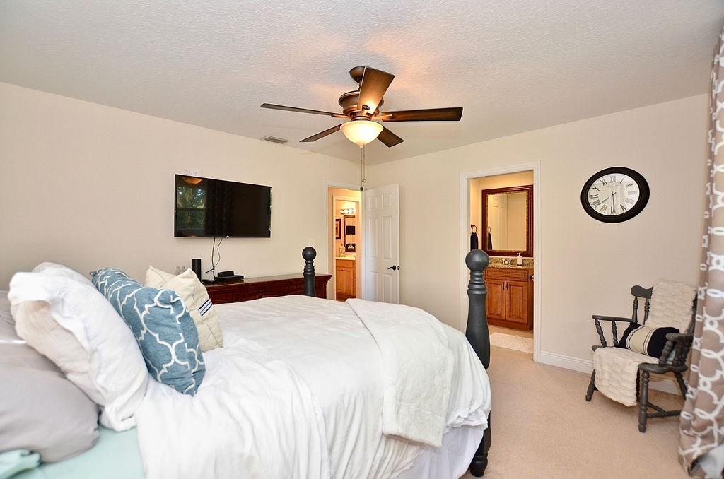 459 Southwest Byron Street Port St. Lucie, FL 34983 - Photo 31 of 51 a bedroom with bed tv and a window