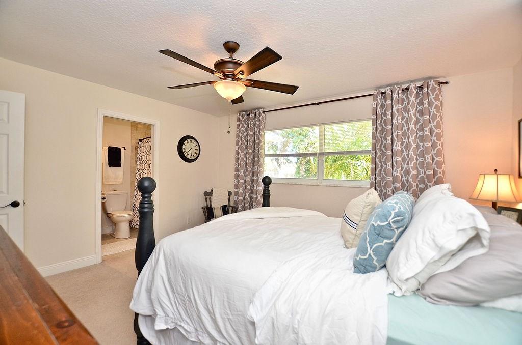 459 Southwest Byron Street Port St. Lucie, FL 34983 - Photo 32 of 51 a bedroom with a large bed and a window