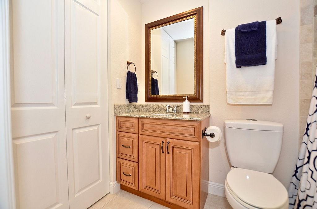 459 Southwest Byron Street Port St. Lucie, FL 34983 - Photo 33 of 51 a bathroom with a granite countertop toilet sink and mirror