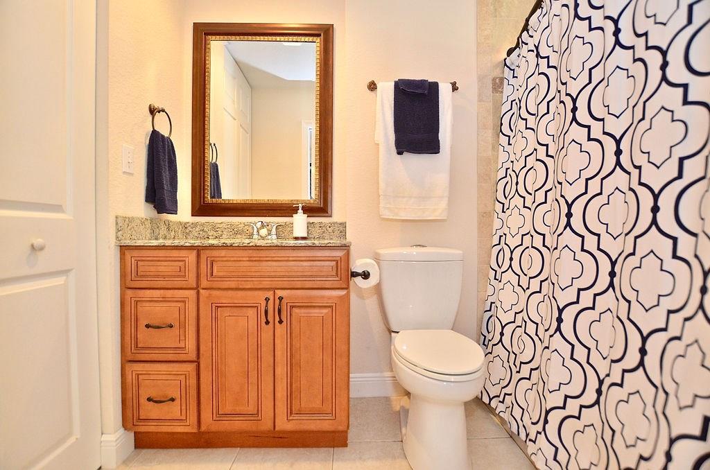 459 Southwest Byron Street Port St. Lucie, FL 34983 - Photo 34 of 51 a bathroom with a toilet sink and mirror