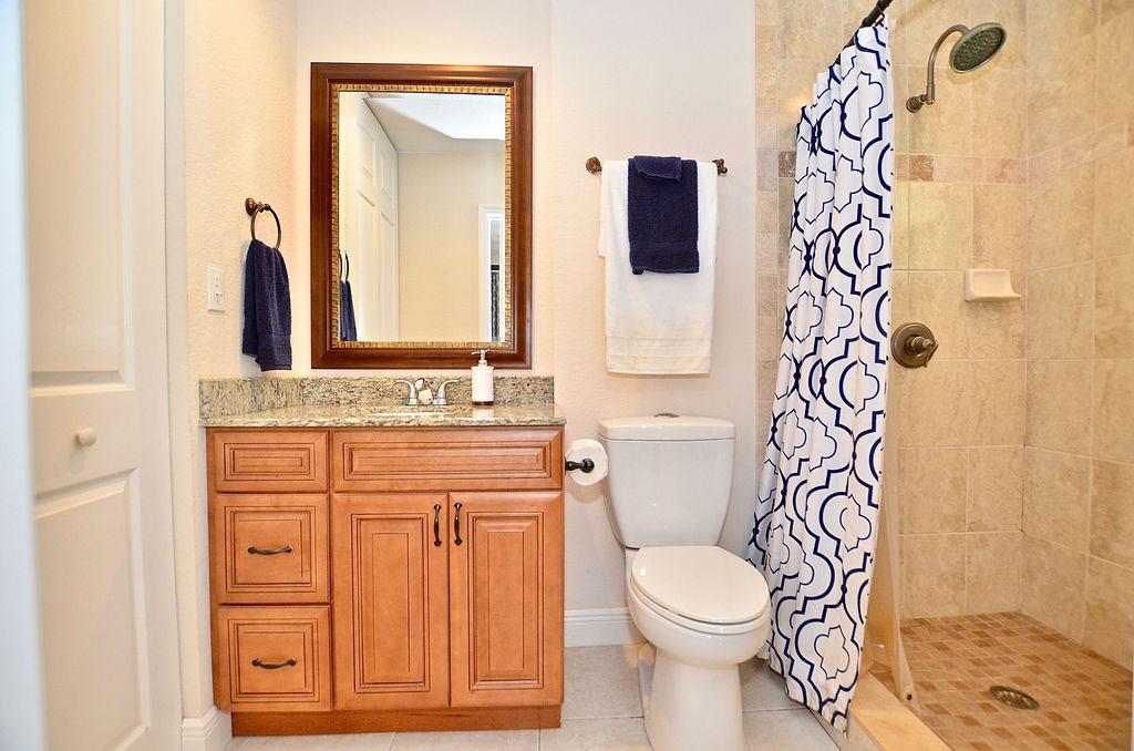459 Southwest Byron Street Port St. Lucie, FL 34983 - Photo 35 of 51 a bathroom with a granite countertop toilet sink and mirror