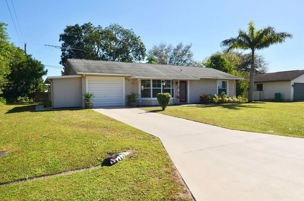 459 Southwest Byron Street Port St. Lucie, FL 34983 - Photo 4 of 51 a view of a house with a yard and potted plants