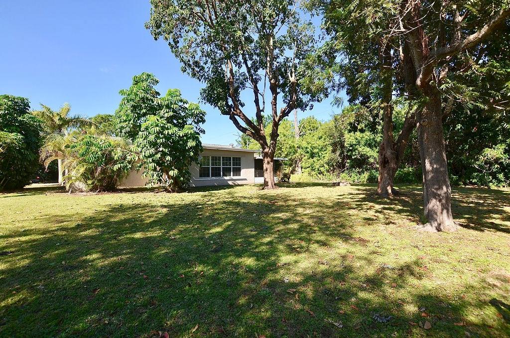 459 Southwest Byron Street Port St. Lucie, FL 34983 - Photo 43 of 51 a front view of a house with a yard