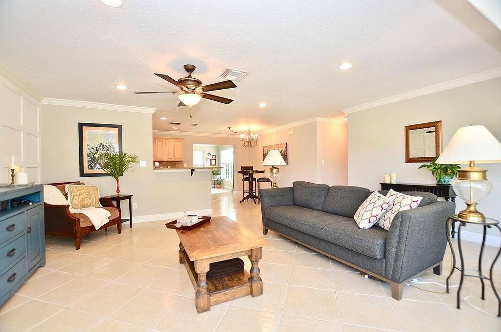 459 Southwest Byron Street Port St. Lucie, FL 34983 - Photo 8 of 51 a living room with furniture and a chandelier