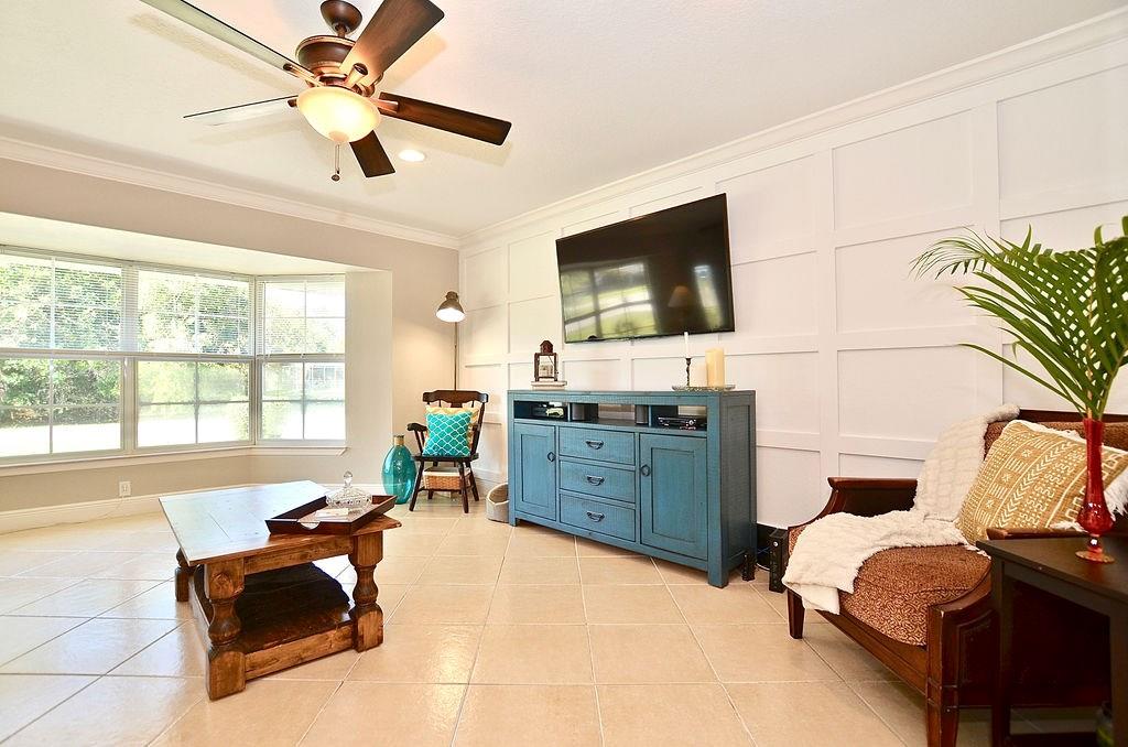 459 Southwest Byron Street Port St. Lucie, FL 34983 - Photo 10 of 51 a living room with furniture and a flat screen tv