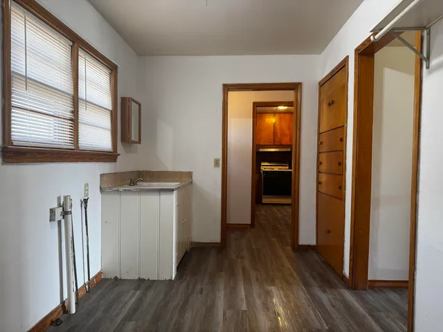 a view of hallway with wooden floor and stairs