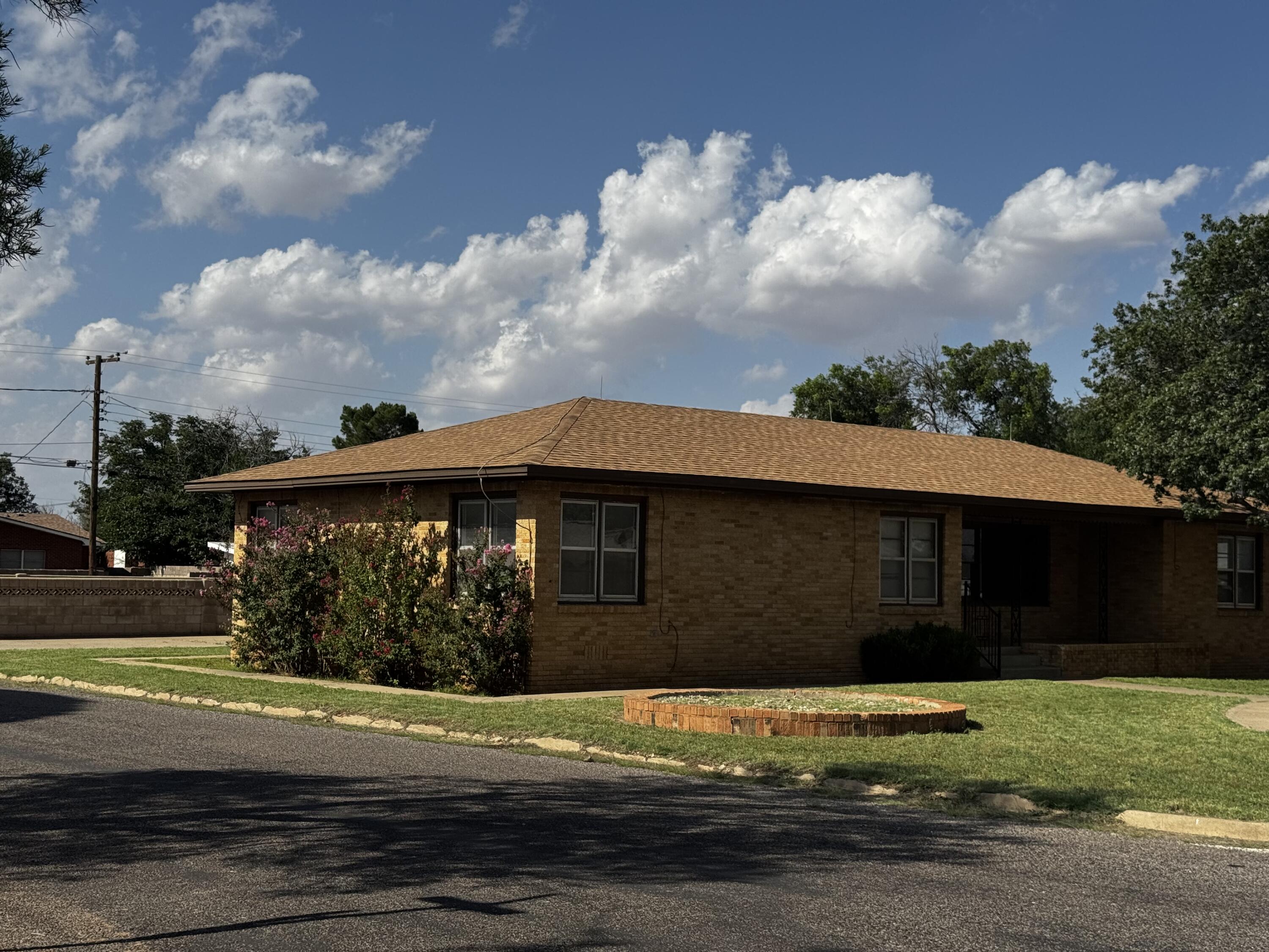 110 North 15th Street Lamesa, TX 79331 - Photo 3 of 28 a front view of a house with a garden