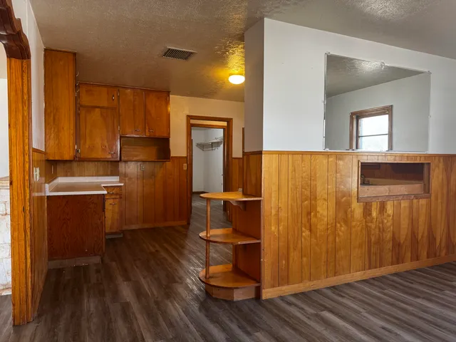 a view of kitchen with wooden floor and electronic appliances
