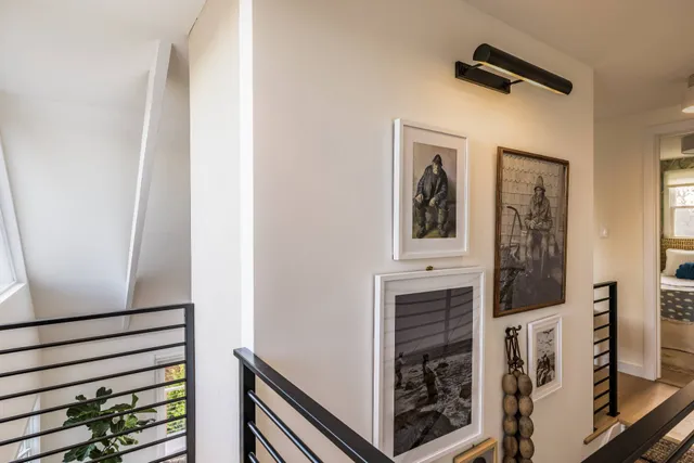 a view of a hallway with wooden floor and staircase