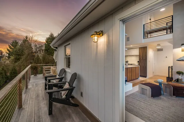 a balcony view with a couch and wooden floor