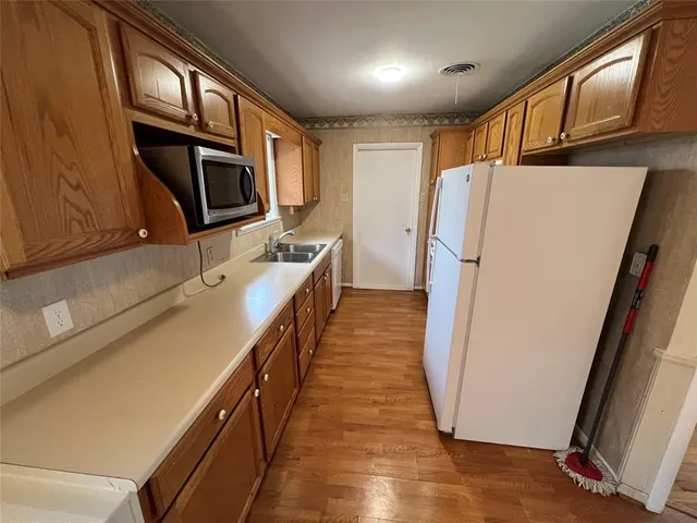 a kitchen with stainless steel appliances a refrigerator and a microwave