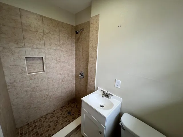 a bathroom with a sink toilet and shower