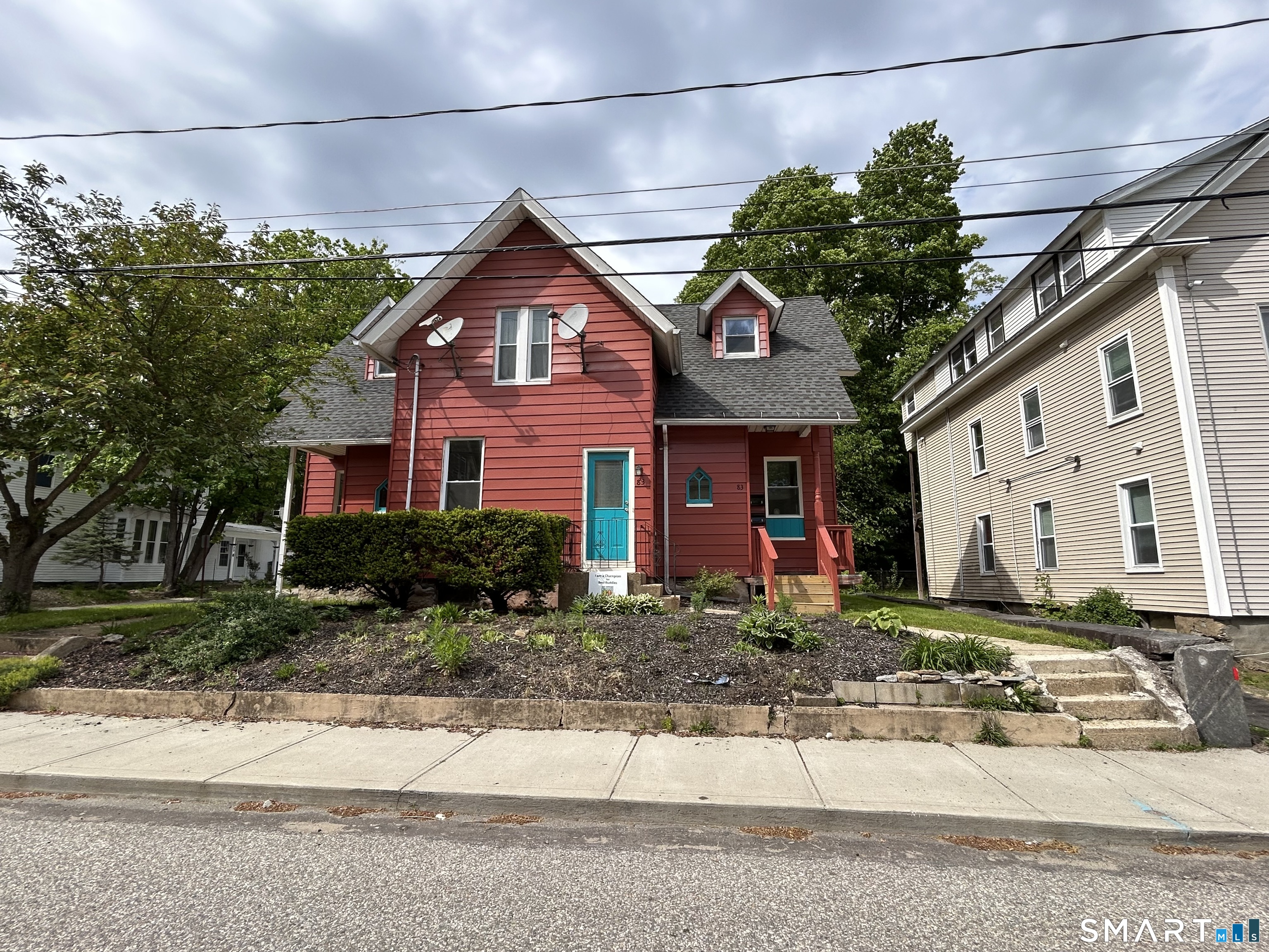 83 Spring Street, Unit 1 Windham, CT 06226 - Photo 1 of 1 a front view of a house with garden