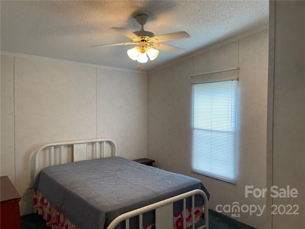 97 County Rd S-13-678 Jefferson, SC 29718 - Photo 17 of 24 a bedroom with a bed and a chandelier
