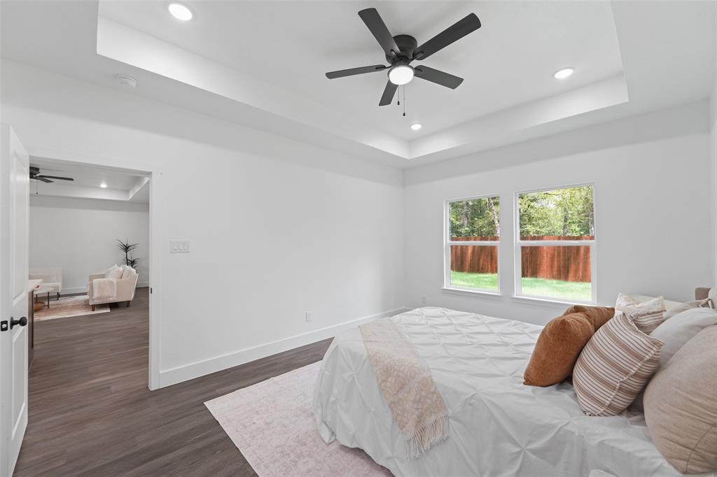 122 East Beachwood Loop Trinidad, TX 75163 - Photo 19 of 35 Room featuring wood-finish flooring, a tray ceiling with recessed lighting, and a ceiling fan