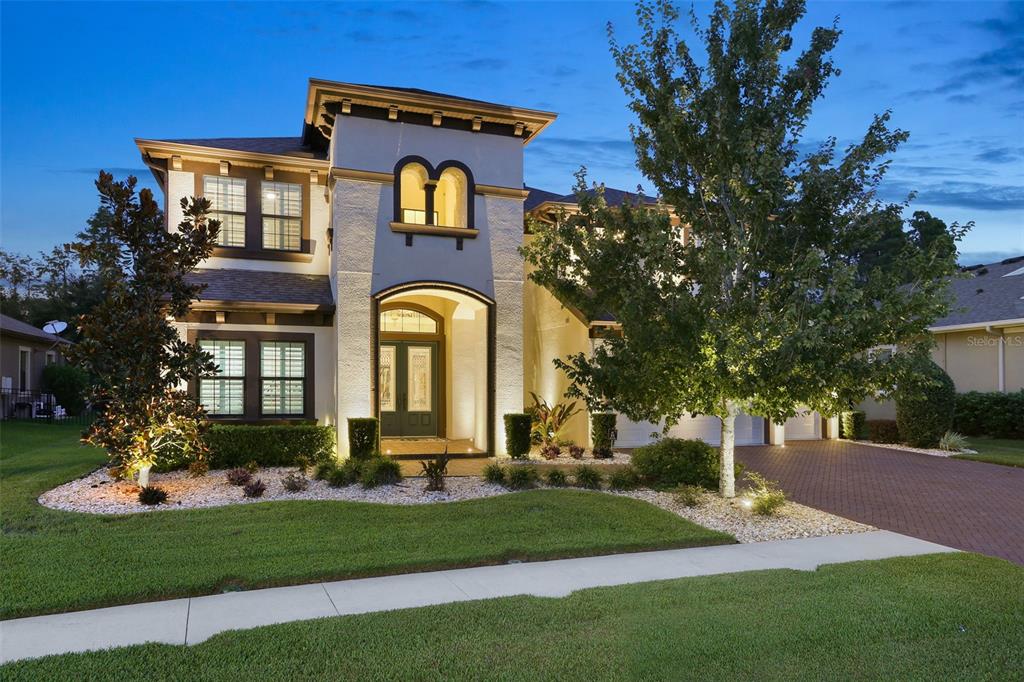 19351 Ranchview Court Land O Lakes, FL 34638 - Photo 1 of 1 a front view of a house with a garden
