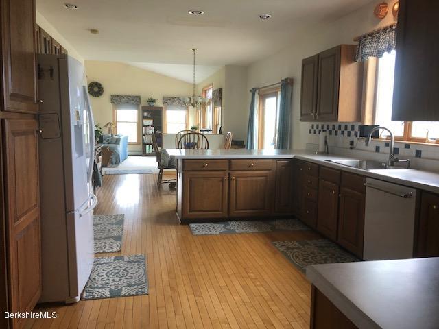 110 Hill Cemetery Road Windsor, MA 01270 - Photo 17 of 52 a large kitchen with lots of counter space a sink dishwasher a dining table and chairs