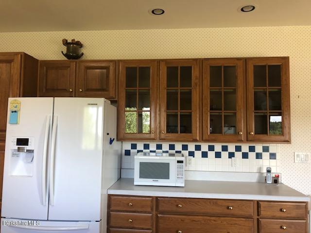 110 Hill Cemetery Road Windsor, MA 01270 - Photo 20 of 52 a kitchen with a refrigerator and cabinets