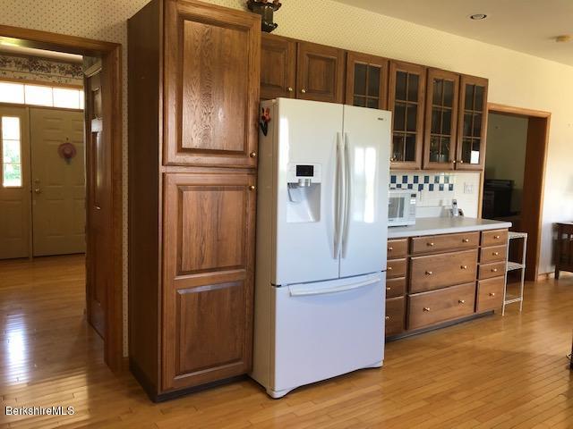 110 Hill Cemetery Road Windsor, MA 01270 - Photo 21 of 52 a kitchen with cabinets stainless steel appliances and wooden floor