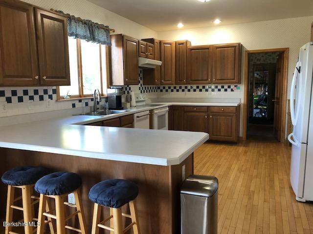 110 Hill Cemetery Road Windsor, MA 01270 - Photo 23 of 52 a kitchen with a sink a stove a refrigerator and cabinets