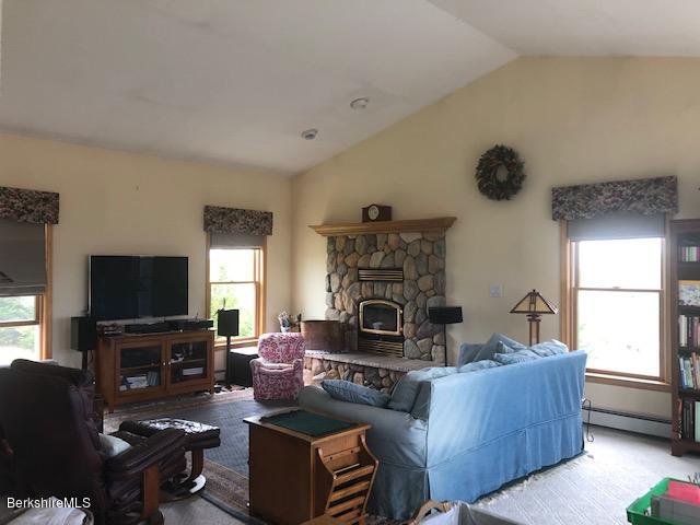 110 Hill Cemetery Road Windsor, MA 01270 - Photo 26 of 52 a living room with furniture a fireplace and a flat screen tv