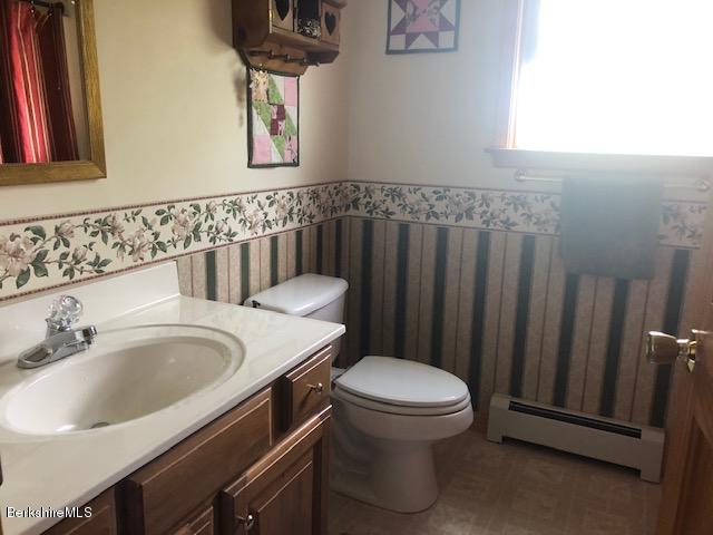 110 Hill Cemetery Road Windsor, MA 01270 - Photo 32 of 52 a bathroom with a sink a toilet and a mirror