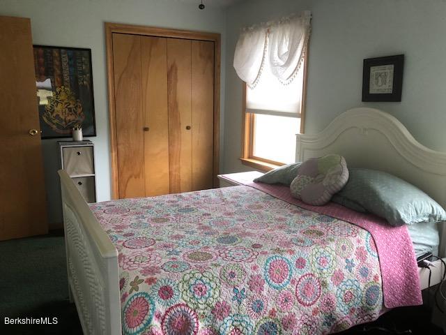110 Hill Cemetery Road Windsor, MA 01270 - Photo 33 of 52 a bedroom with a bed and a chandelier