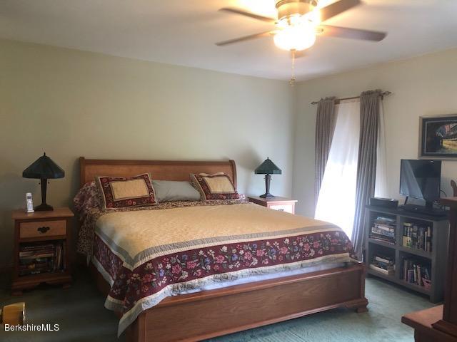 110 Hill Cemetery Road Windsor, MA 01270 - Photo 36 of 52 a bedroom with a bed and a flat tv screen on dresser
